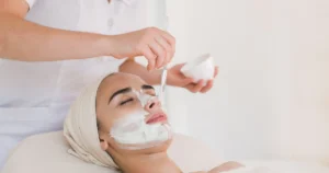 Woman getting a facial as a white mask is applied with a brush in Tracy, CA
