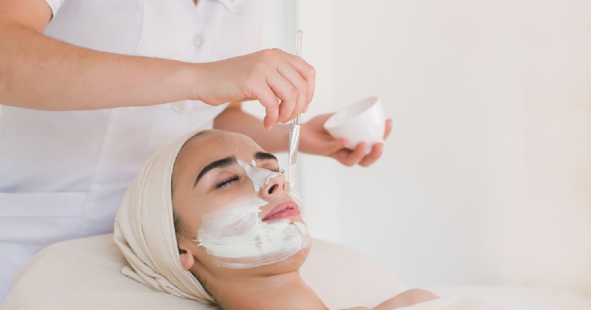 Woman getting a facial as a white mask is applied with a brush in Tracy, CA