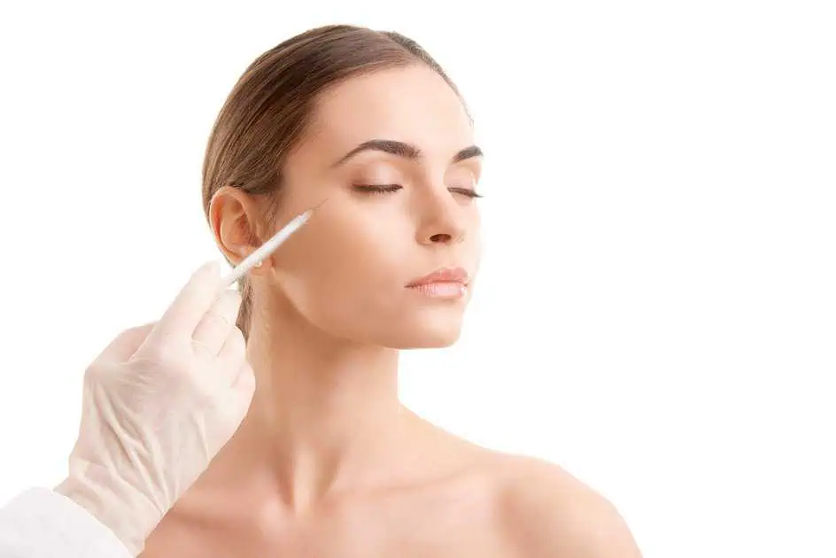 Woman receiving botox injection on the cheek by a gloved medical professional in Tracy, CA | A Perfect Finnish Medical Spa